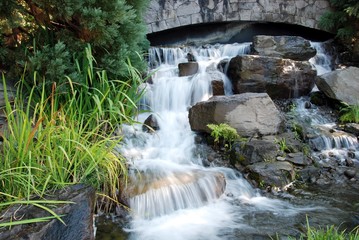 water fall under bridge