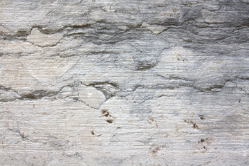 Old concrete wall with cracks and damage on gray stucco texture background