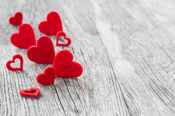 Plakat Valentines Day background. Red hearts on wooden background. Selective focus 