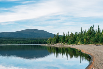 Forest and mountain reflection in lake