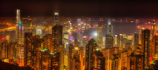 Panorama of Hong Kong, China. Spectacular night view of Victoria Harbour skyline from Victoria Peak. The Peak is the highest mountain in Hong Kong Island.