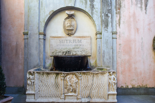 sculpted old fountain in Sutri