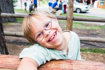 Little Boy With Downs-Syndrome Sitting at Table