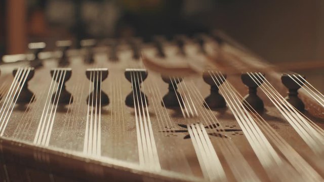 Someone is playing the ethnic musical instrument - santur