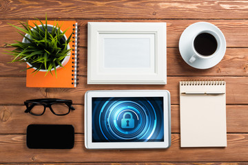 Web security and technology concept with tablet pc on wooden table