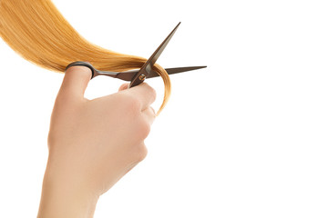 Hand cut split ends by hair scissors isolated on white