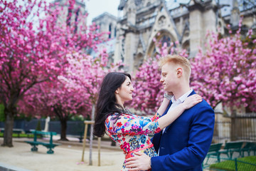 Romantic couple in Paris with cherry blossom trees