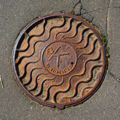 Manhole cover on the asphalt