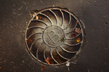 Manhole cover on the asphalt