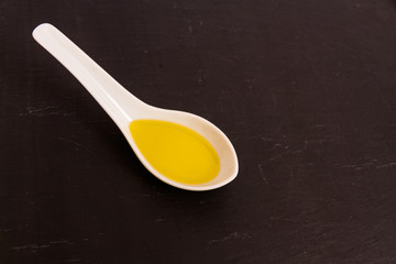 Olive oil on ceramic spoon