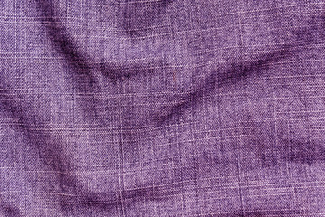 Fototapeta na wymiar Purple color denim textile cloth surface.