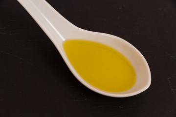 Olive oil on ceramic spoon