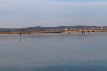 Ice-skaters on  lake Neusiedl, Neusiedler See, Austria