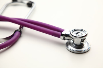 Stethoscope with cardiogram lying on desk in hospital
