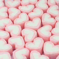 Pink heart shaped marshmallows background