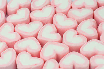 Pink heart shaped marshmallows background