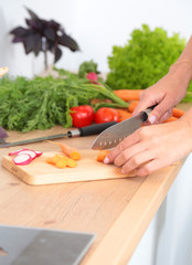 Fresh vegetables on the cutting board are falling in the pot, concept of cooking