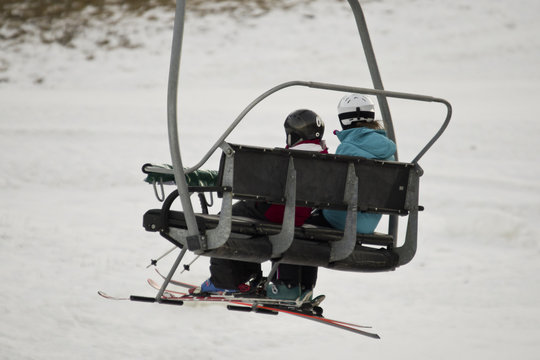 Chairlift with skiers at a ski resort