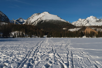 Winter view of frozen surface of Strbske Pleso (Tarn) and snowy  peaks High Tatra mountains. Strbske Pleso is second largest glacial lake on the Slovak side of the High Tatra Mountains. - 133249082