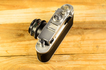 Old soviet rangefinder camera on a wooden table