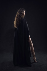 Naklejka na ściany i meble Beautiful naked gothic girl in a black cloak