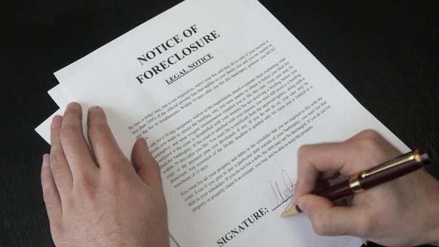 Signing a notice of foreclosure document.