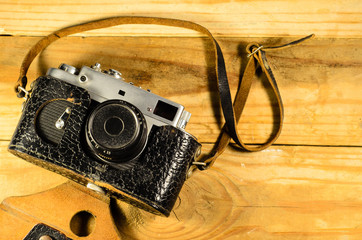 Old soviet rangefinder camera on a wooden table