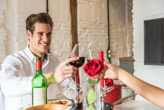 couple celebrating Valentine's day toasting in a dinner at home