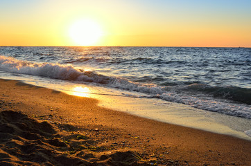 Fototapeta na wymiar Seacoast on a background of the rising sun