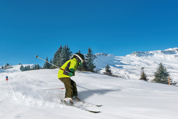 Fototapeta na wymiar boy skiing fast in alpes