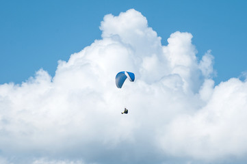 Paraglider flying in the sky. Paragliding. Paraglider flying near clouds.