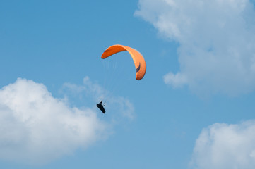 Paraglider flying in the sky. Paragliding. Paraglider flying near clouds.