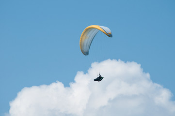 Paraglider flying in the sky. Paragliding. Paraglider flying near clouds.