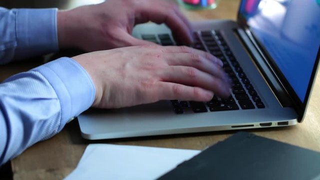 Man working on a macbook in cafe