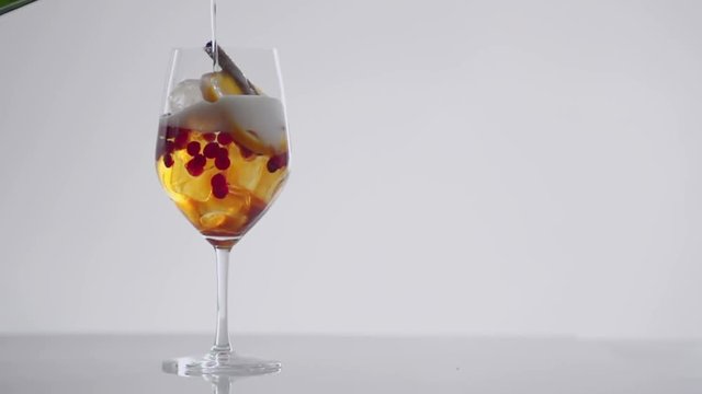 CLOW MOTION: pouring soda into a glass with a cocktail