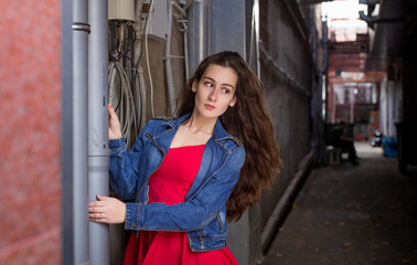 Fashionable stylish beautiful girl with long hair in old abandoned place summer day