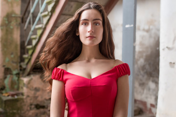 Fashionable stylish beautiful girl with long hair in old abandoned place summer day