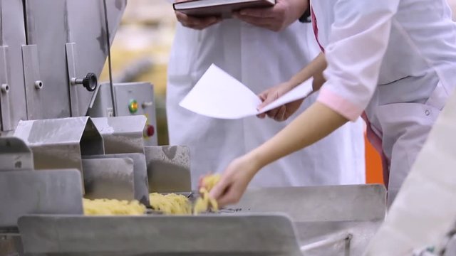 Checking the product quality on the macaroni factory