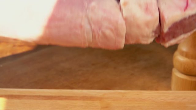 Close-up of cutting sheep's legs on a wooden board