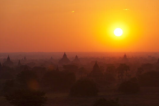 Golden sunrise over the temples of Bagan, Myanmar in the fog 