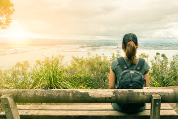 Young woman tourist enjoys the ocean view in Mt Maunganui