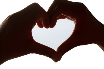 Obraz premium Silhouette of heart shape hand