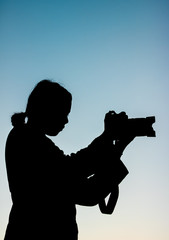 silhouette of a woman with camera
