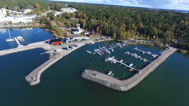 Aerial flight view tilting towards Forby harbor, in the finnish archipelago at Isoluoto, Varsinais-Suomi, Finland