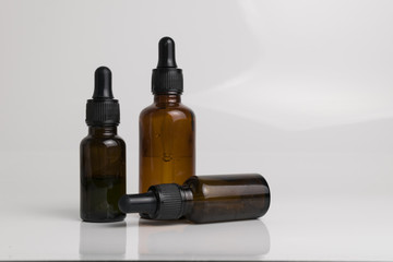 isolated drop glass bottle in brown color.