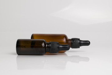 isolated drop glass bottle in brown color.