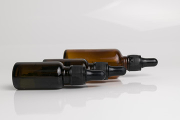 isolated drop glass bottle in brown color.