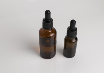 isolated drop glass bottle in brown color.