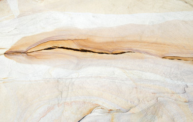 Fototapeta na wymiar close up natural coloured patterns in the sandstone rock