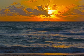 Dramatic sunrise with clouds over the ocean. Cloudy skies over the ocean.